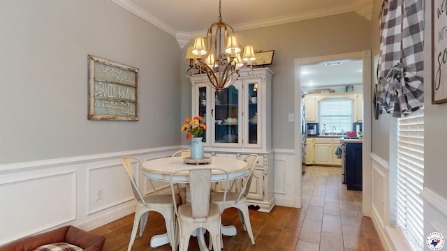 142 Corley Cir, Wake Village, TX 75501 - dining room featuring a decorative wall, a chandelier, ornamental molding, wood finished floors, and a wainscoted wall