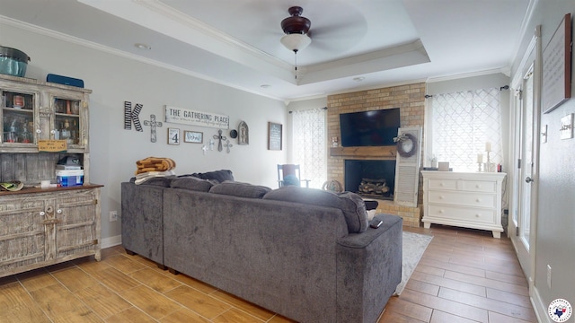 142 Corley Cir, Wake Village, TX 75501 - living room with ceiling fan, wood finished floors, ornamental molding, a brick fireplace, and a tray ceiling
