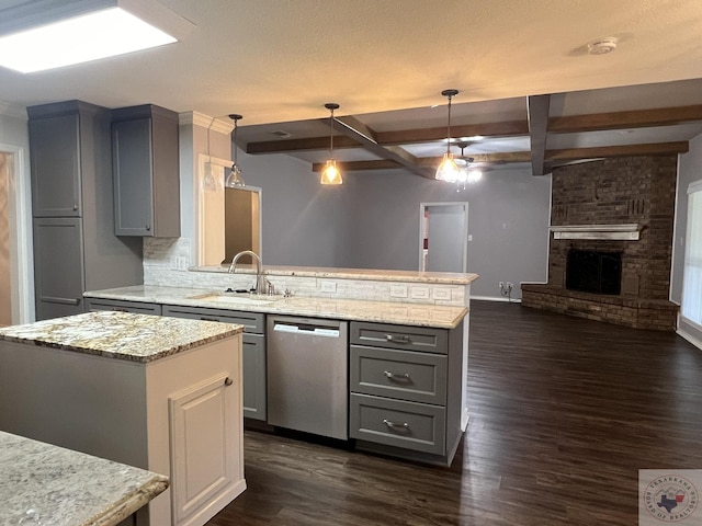 kitchen featuring a center island, dishwasher, hanging light fixtures, sink, and beam ceiling