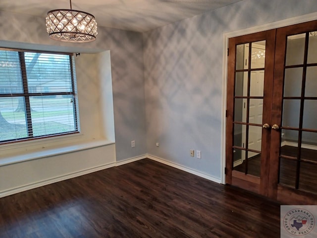 spare room featuring dark hardwood / wood-style floors and french doors