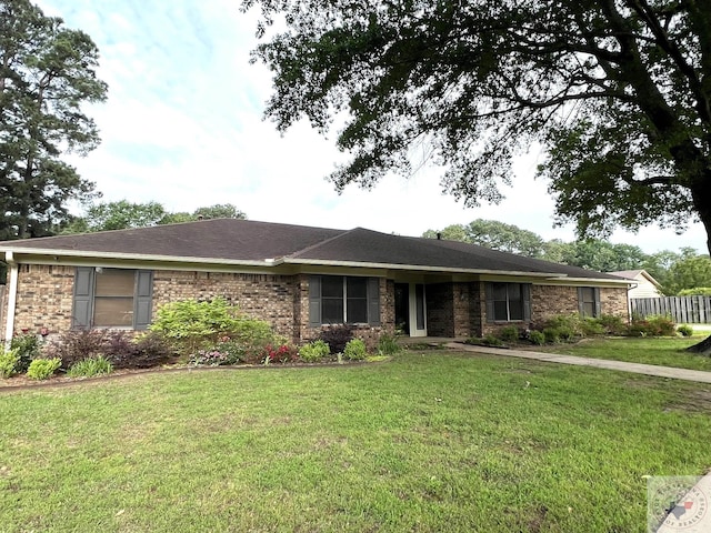 ranch-style home featuring a front yard