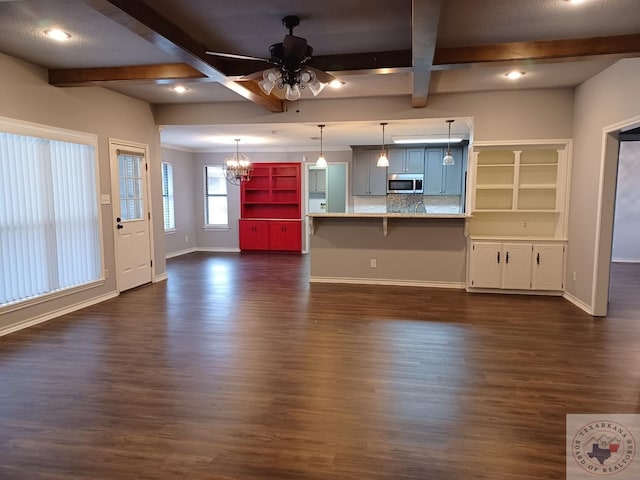 unfurnished living room with ceiling fan, coffered ceiling, beam ceiling, and dark hardwood / wood-style flooring