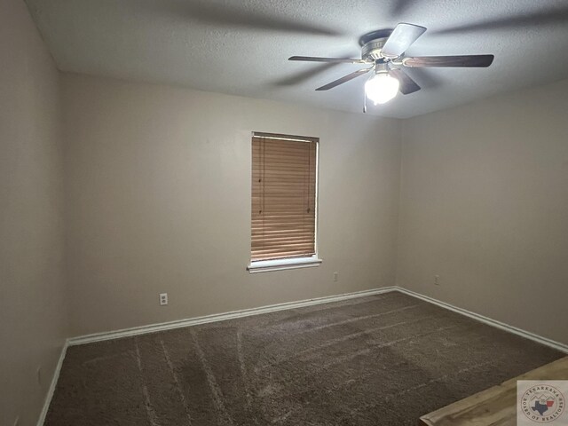 empty room with ceiling fan, a textured ceiling, and carpet