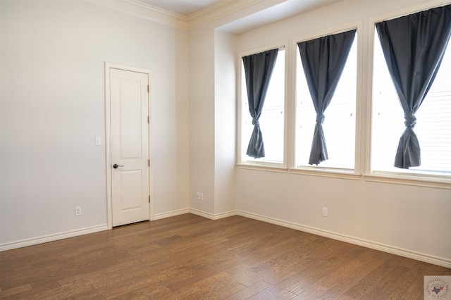 unfurnished room featuring ornamental molding and wood-type flooring