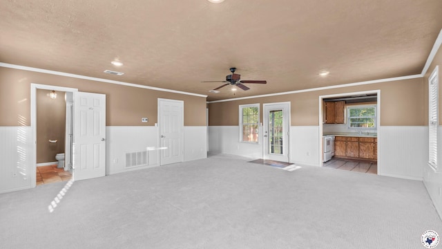 6616 Lakeridge Dr, Texarkana, TX 75503 - unfurnished living room featuring wainscoting, light colored carpet, ceiling fan, crown molding, and recessed lighting