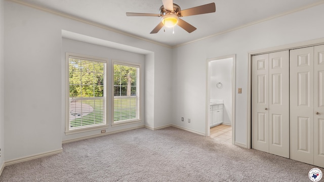 6616 Lakeridge Dr, Texarkana, TX 75503 - unfurnished bedroom featuring light carpet, ornamental molding, a closet, connected bathroom, and ceiling fan