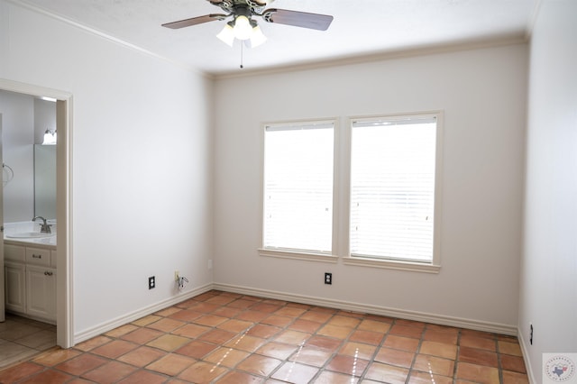 tiled spare room with ceiling fan, sink, and crown molding