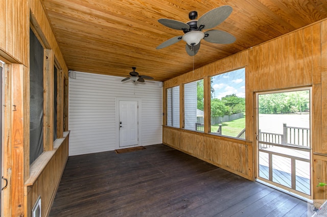 unfurnished sunroom featuring a healthy amount of sunlight and wood ceiling