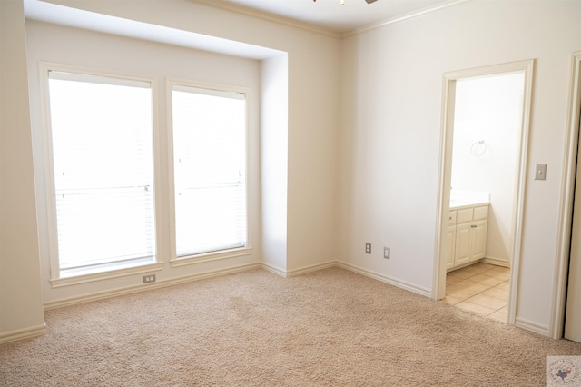 carpeted empty room featuring ceiling fan and crown molding