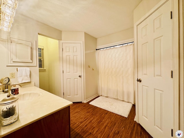 3705 Fm 2148 N, Texarkana, TX 75503 - full bathroom with wood finished floors, a textured ceiling, vanity, and curtained shower