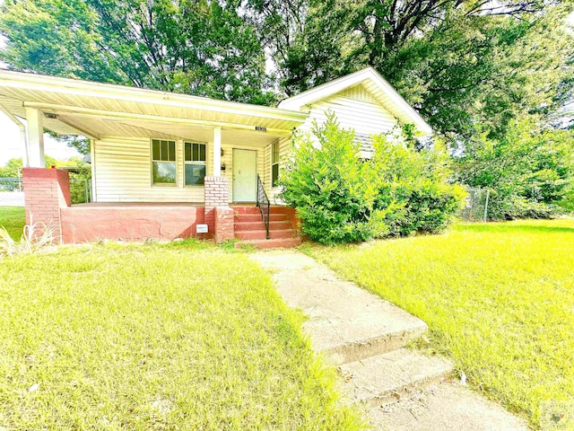 view of front of property with a front yard and a porch