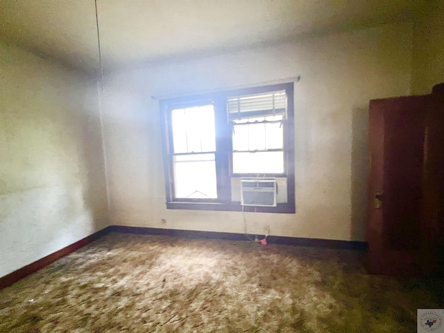 carpeted spare room featuring cooling unit