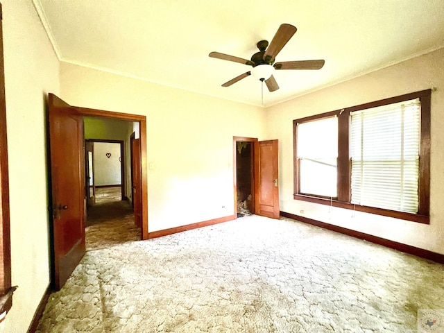 unfurnished bedroom with carpet floors, ceiling fan, and ornamental molding