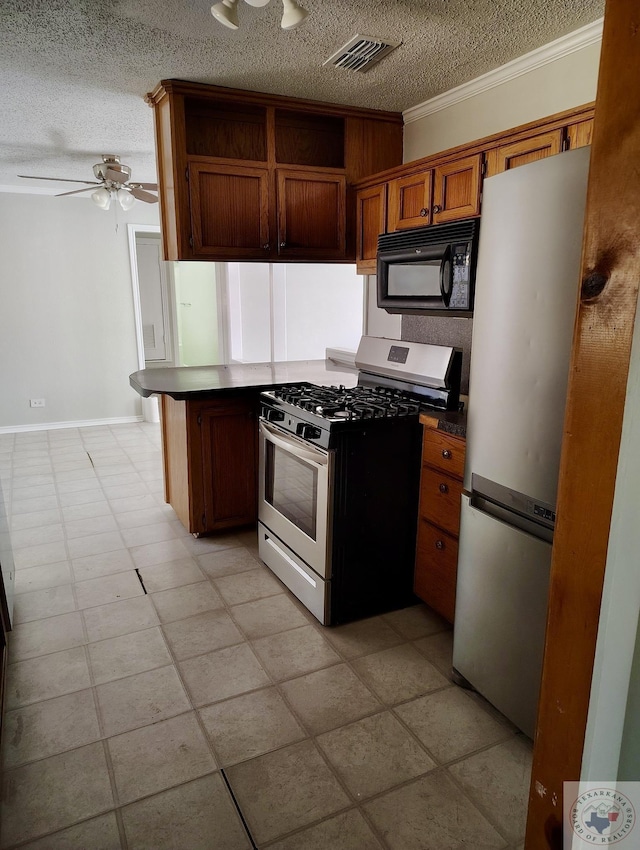 kitchen with kitchen peninsula, ornamental molding, a textured ceiling, and appliances with stainless steel finishes