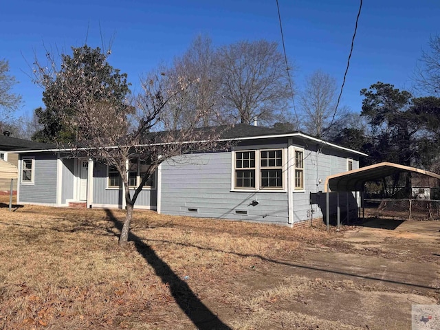 view of front of home with crawl space, a front yard, and a detached carport