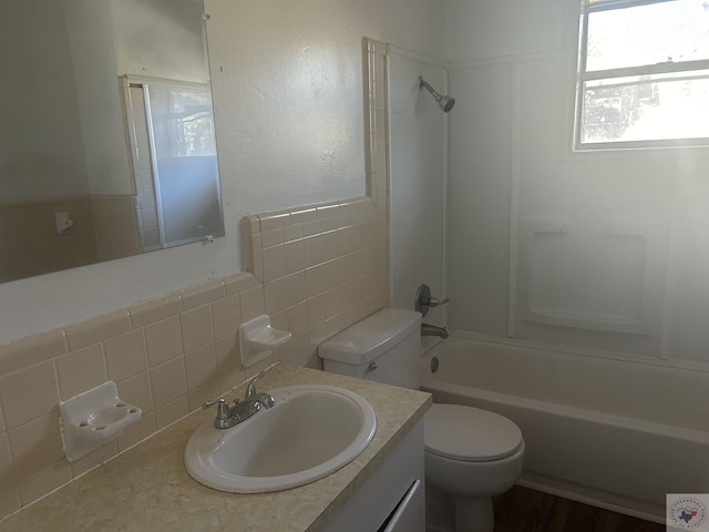 full bathroom featuring toilet, vanity, and bathing tub / shower combination