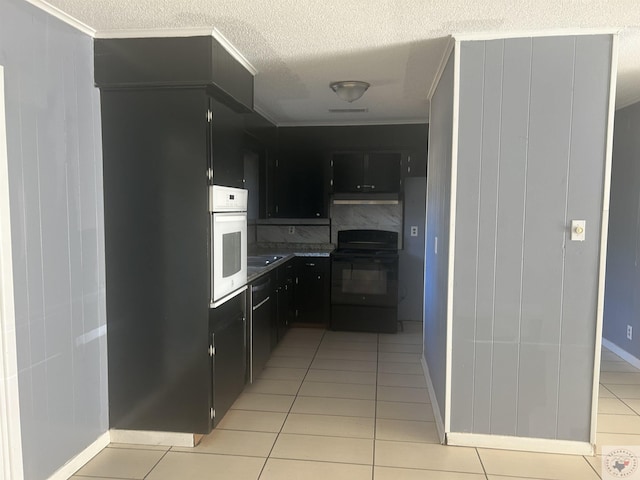 kitchen featuring white oven, black electric range, light tile patterned flooring, ornamental molding, and decorative backsplash