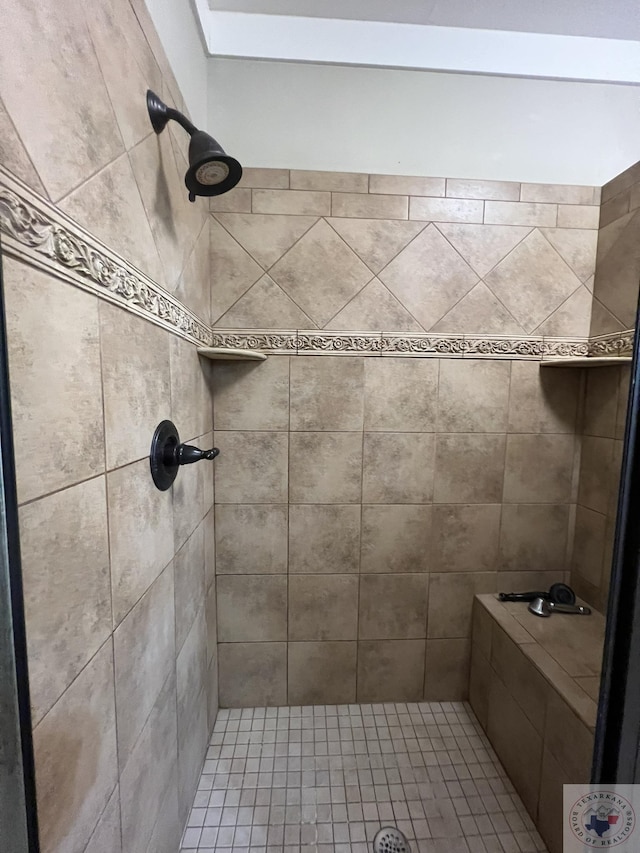 bathroom with a tile shower