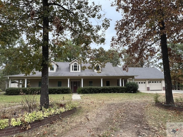 cape cod house featuring a garage and a front yard