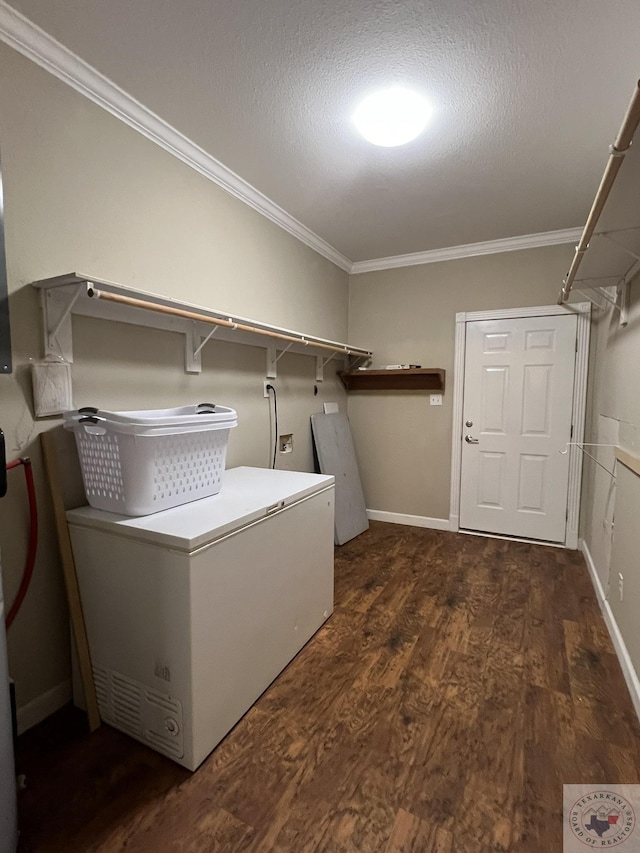 washroom featuring dark wood-type flooring, a textured ceiling, and ornamental molding