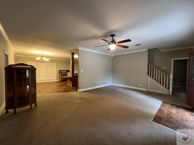 unfurnished living room featuring ceiling fan with notable chandelier, ornamental molding, and dark colored carpet