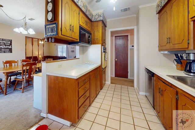 kitchen with visible vents, appliances with stainless steel finishes, brown cabinets, decorative light fixtures, and light countertops