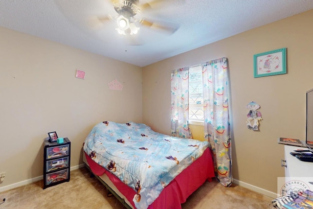 bedroom with a textured ceiling, carpet, a ceiling fan, and baseboards