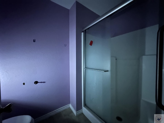 bathroom with a shower with door