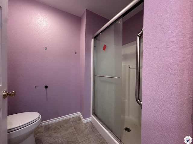 5611 Larry Dr, Texarkana, TX 75503 - full bath with tile patterned floors, toilet, a shower stall, and baseboards