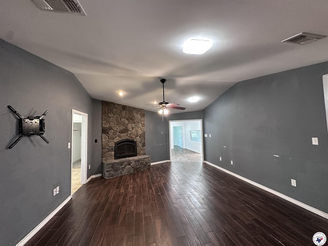 5611 Larry Dr, Texarkana, TX 75503 - unfurnished living room with baseboards, vaulted ceiling, a fireplace, dark wood-type flooring, and visible vents