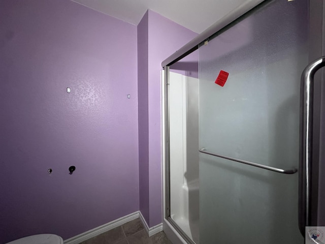 bathroom featuring a shower with shower door and tile patterned floors