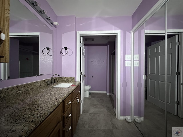 bathroom with vanity, toilet, and a shower with shower door