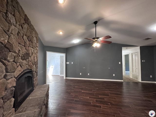 5611 Larry Dr, Texarkana, TX 75503 - unfurnished living room with a stone fireplace, vaulted ceiling, visible vents, ceiling fan, and wood finished floors