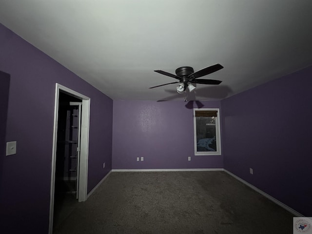 spare room with ceiling fan and carpet