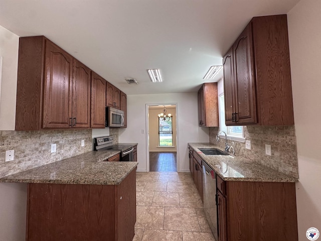 5611 Larry Dr, Texarkana, TX 75503 - kitchen featuring visible vents, baseboards, a sink, appliances with stainless steel finishes, and decorative backsplash