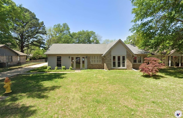 5611 Larry Dr, Texarkana, TX 75503 - rear view of house with brick siding, french doors, and concrete driveway
