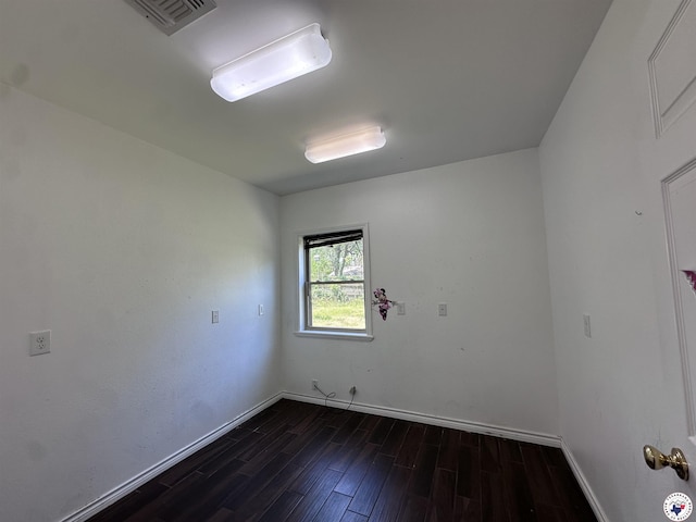 5611 Larry Dr, Texarkana, TX 75503 - unfurnished room with visible vents, dark wood-style flooring, and baseboards