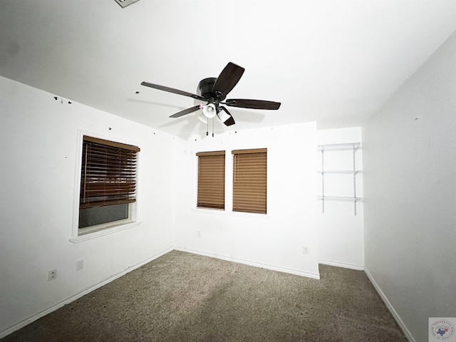 carpeted spare room with ceiling fan