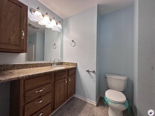 5611 Larry Dr, Texarkana, TX 75503 - bathroom with vanity, tile patterned flooring, visible vents, toilet, and baseboards