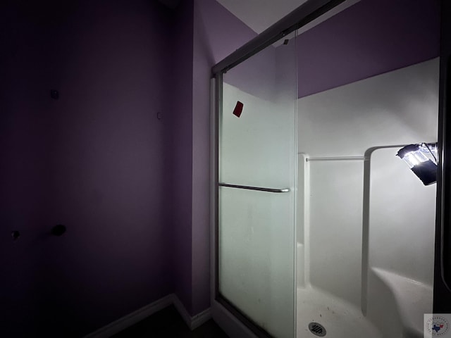 bathroom with a shower with door