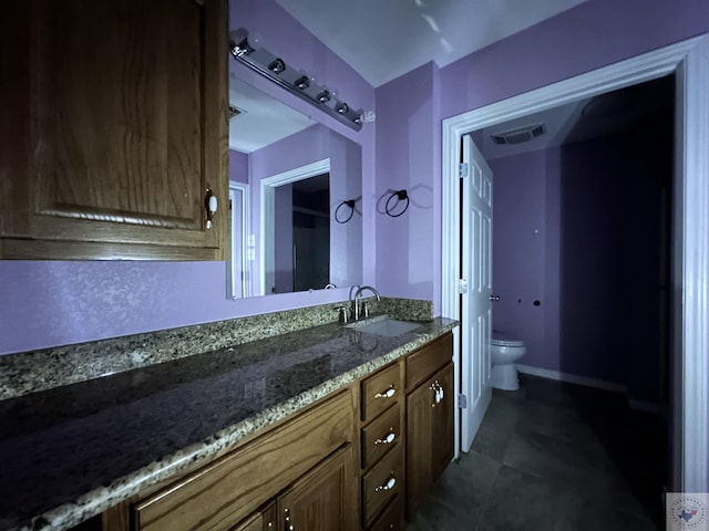 bathroom with vanity, tile patterned floors, and toilet