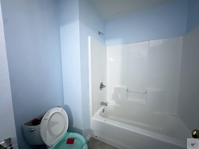 bathroom featuring shower / tub combination and toilet