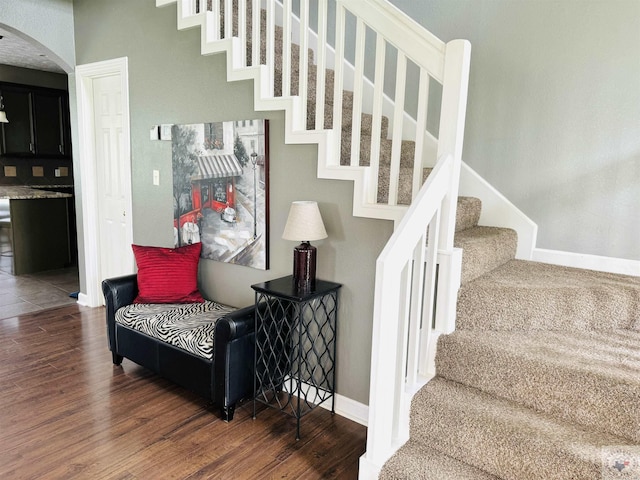 staircase with wood-type flooring