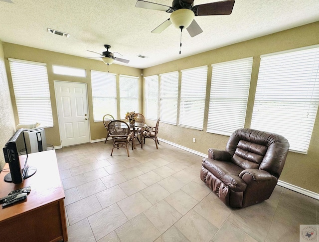 sunroom with ceiling fan