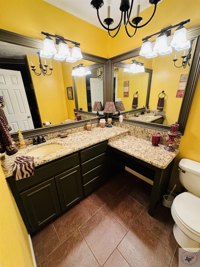 bathroom featuring tile patterned floors, toilet, vanity, and an inviting chandelier