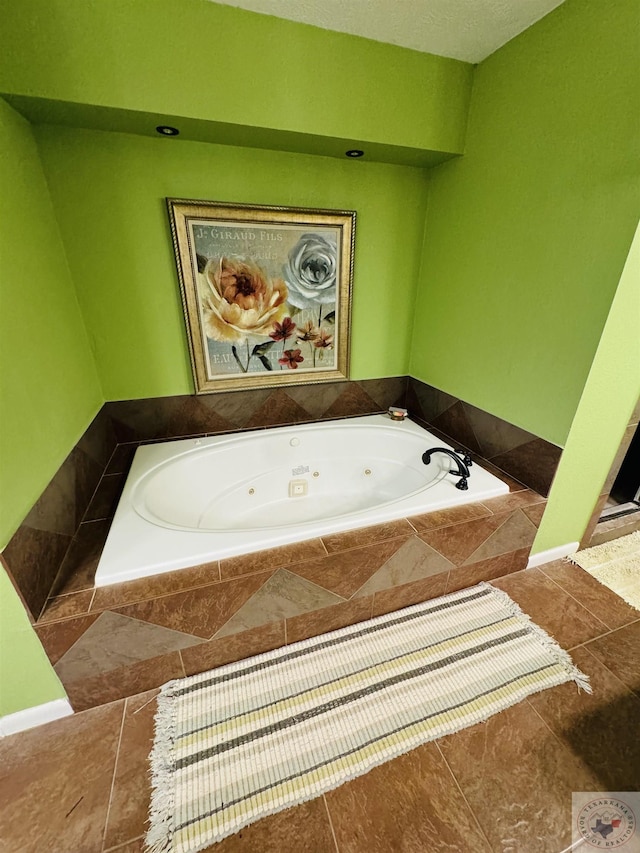 bathroom with tiled bath and tile patterned floors