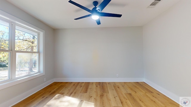 empty room featuring light hardwood / wood-style floors, ceiling fan, and a healthy amount of sunlight