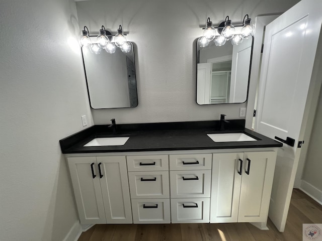 bathroom featuring hardwood / wood-style flooring and vanity