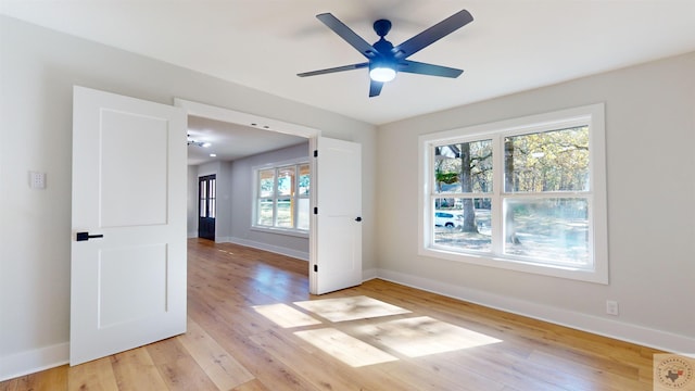 spare room featuring ceiling fan and light hardwood / wood-style floors