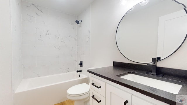 full bathroom featuring toilet, tiled shower / bath, and vanity